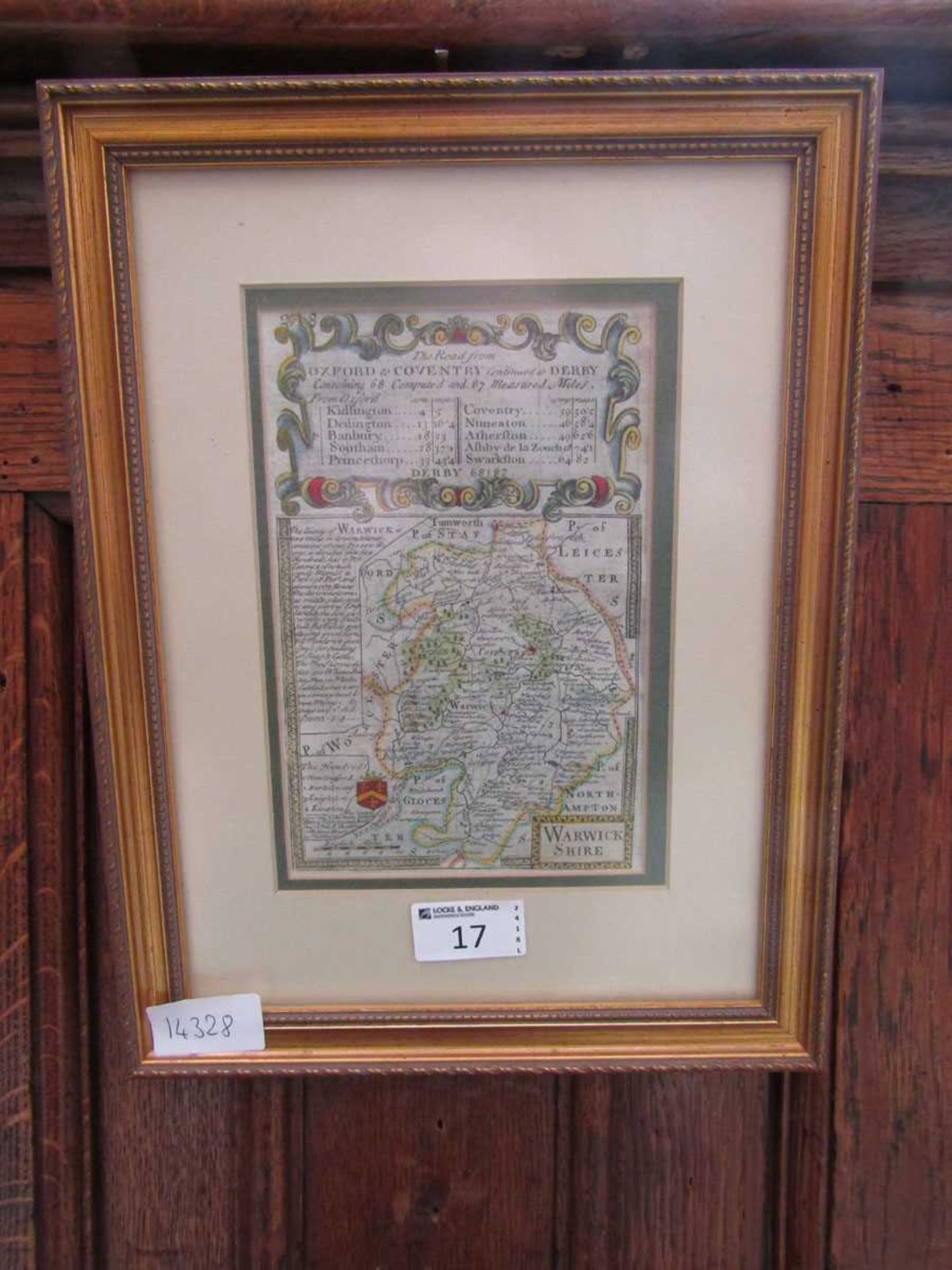A framed and glazed coloured map of Warwickshire