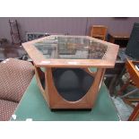 A mid-20th century teak hexagonal occasional table with glass top