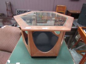 A mid-20th century teak hexagonal occasional table with glass top