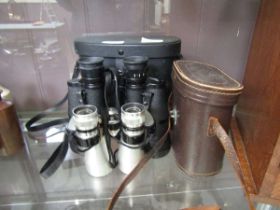 A cased set of 20 x 50 binoculars together with a cased set of micro 10 x 40 binoculars