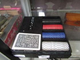 A boxed poker set containing cards, chips, dice, etc