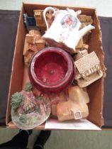 A box containing cottages, cranberry glassware, etc