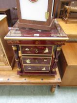 A reproduction Chinese style centre table having glass top and three drawers lacquered in a gilt red