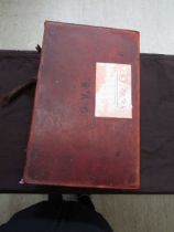 A leather case containing a large quantity of old photographs