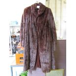 A 3/4 length brown fur coat