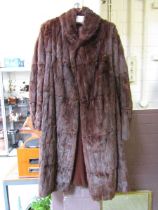 A 3/4 length brown fur coat