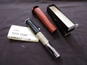 A leather cased Otis King Calculator