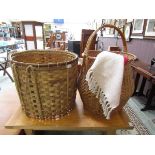 Two wicker baskets, one with handle, together with a French red cotton rug