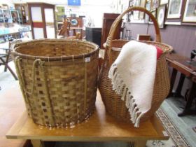 Two wicker baskets, one with handle, together with a French red cotton rug