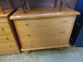 A mid-20th century chest of three drawers