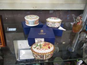 Two boxed Royal Crown Derby lidded pots from the 'Honeysuckle' and 'Wild Rose' series along with one