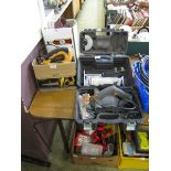 A cased angle grinder along with a cased sander, a boxed electric saw, and a belt sander