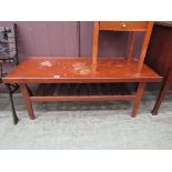 A mid-20th century teak coffee table with slatted under tier