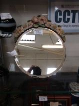 A small 20th century circular easel mirrored with encrusted floral decoration to top