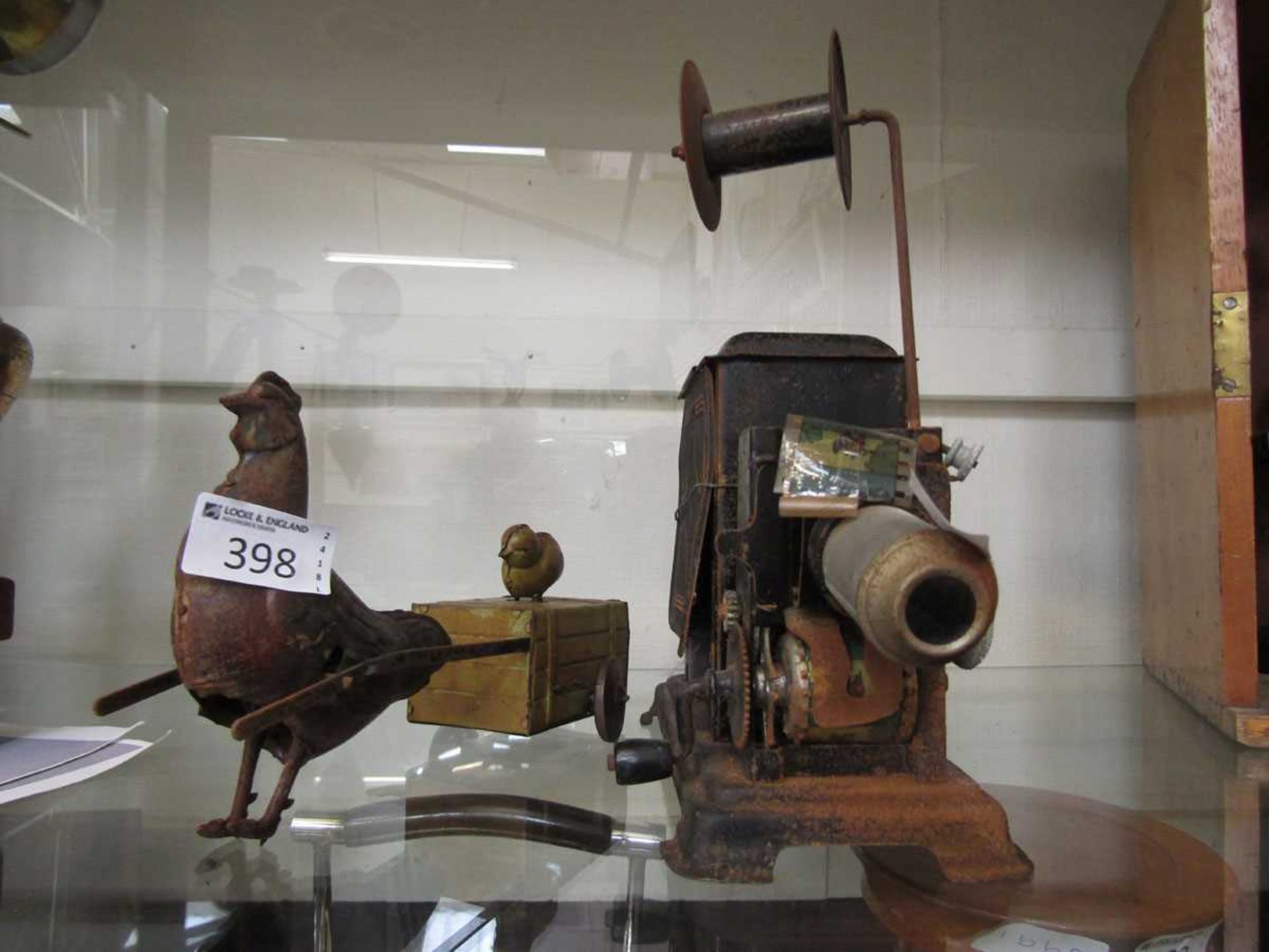 An early 20th century tin plate clockwork toy of mother and chick along with an early 20th century