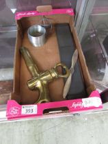 A box containing an assortment of items to include slinky, metalwork model, brass tap, etc
