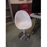 A white Perspex and chrome based chair