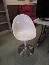A white Perspex and chrome based chair