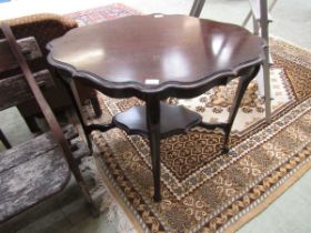 An early 20th century mahogany occasional table with under tier