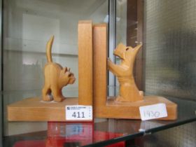 A pair of wooden bookends in the form of cat and dog