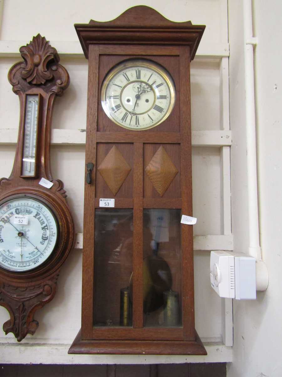 An early 20th century oak Vienna wall clock