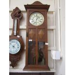 An early 20th century oak Vienna wall clock