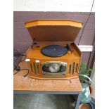 A reproduction oak cased art deco style music centre comprising of turntable, tuner, and CD player