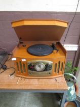 A reproduction oak cased art deco style music centre comprising of turntable, tuner, and CD player
