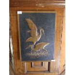 A mid-20th century embossed copper plaque of storks