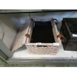 A wicker basket containing a set of six black marble placemats and drinks coasters