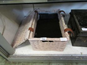 A wicker basket containing a set of six black marble placemats and drinks coasters