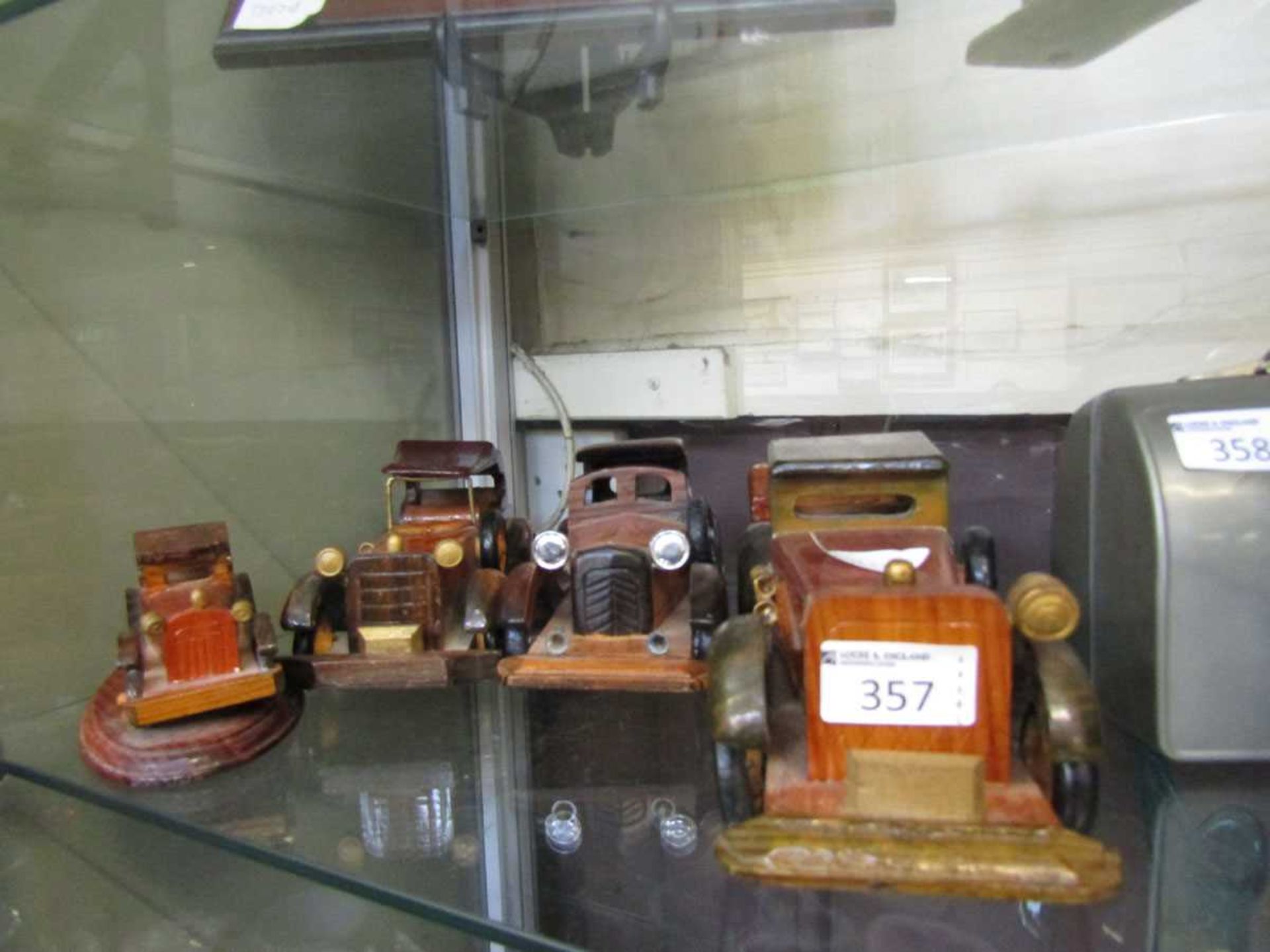 Four 20th century carved wooden models of classic cars