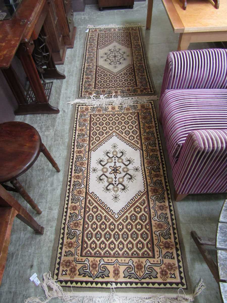 A pair of Tunisian brown and beige ground rectangular rugs