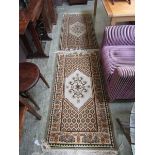 A pair of Tunisian brown and beige ground rectangular rugs