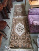 A pair of Tunisian brown and beige ground rectangular rugs