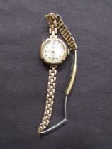 A 9ct gold ladies' wristwatch with yellow metal strap by Bernex