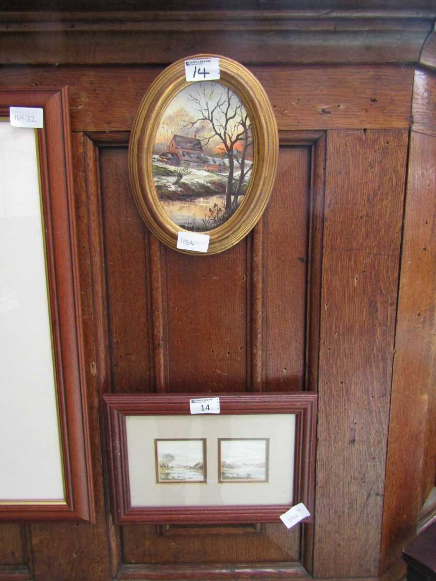 An oval framed oil on board of a winter country scene together with a framed and glazed pair of