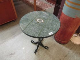 A green marble efect circular occasional table on black metal base
