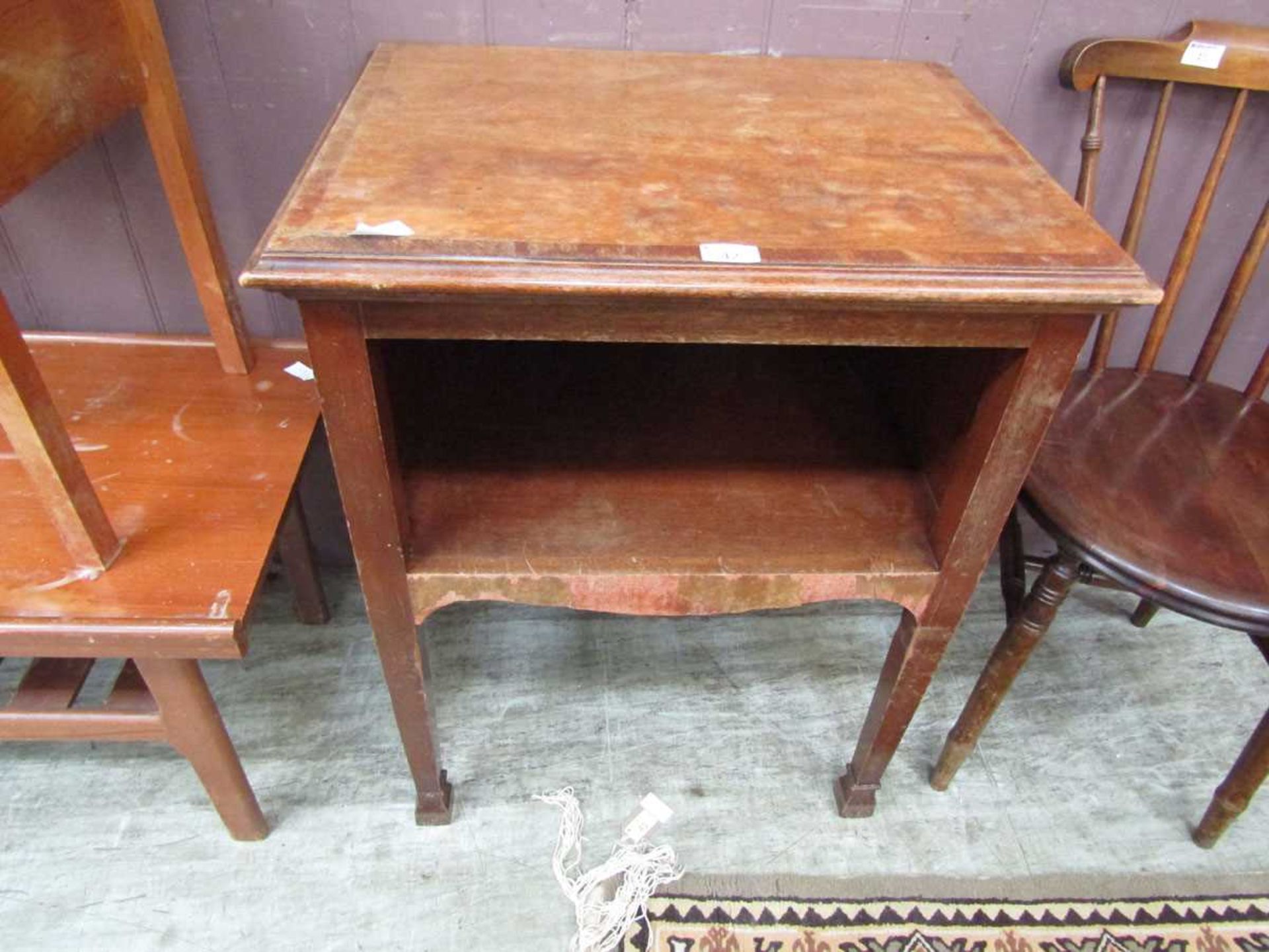 An early 20th century oak and walnut occasional table with open storage