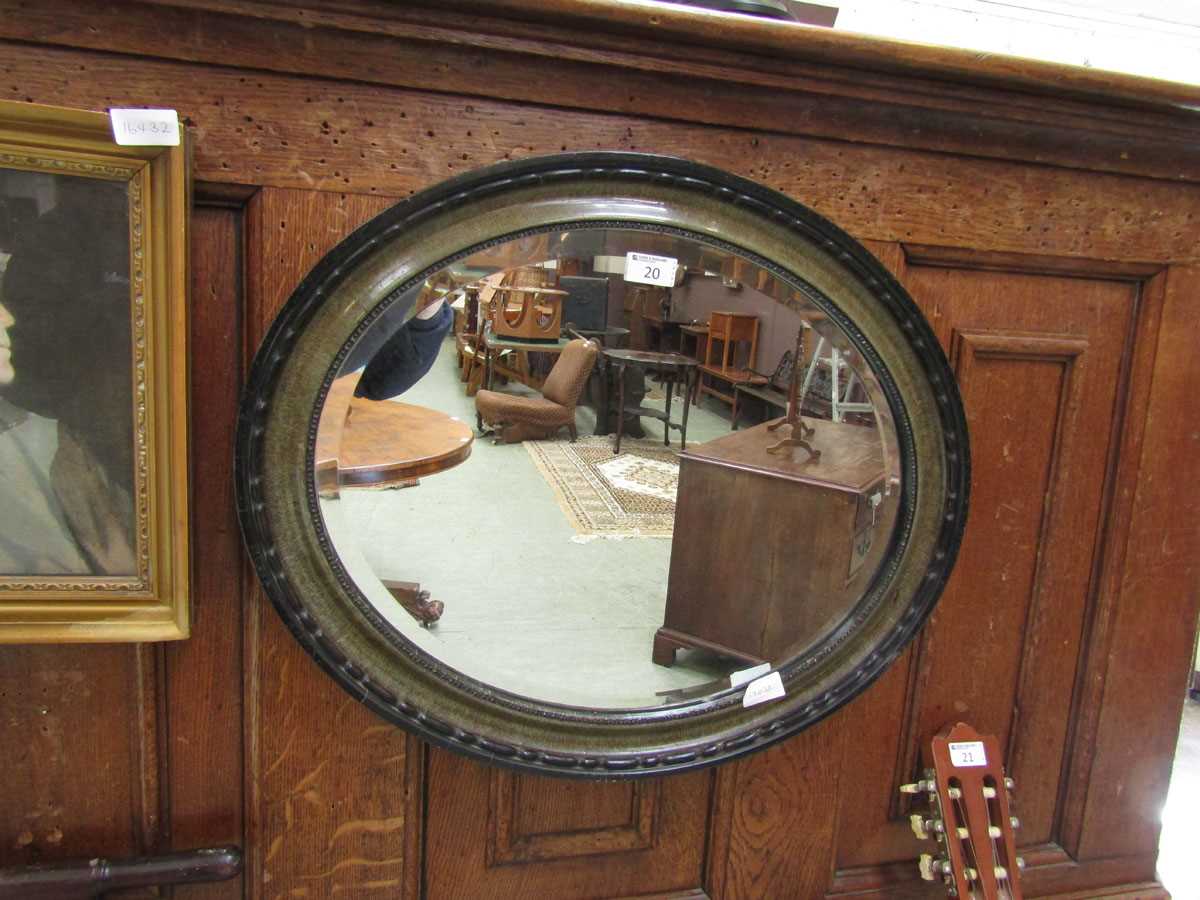 An early 20th century oval bevel glass wall mirror