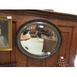 An early 20th century oval bevel glass wall mirror