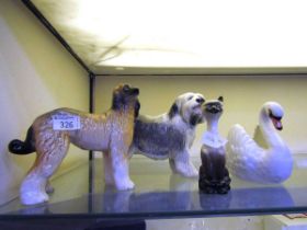 Two ceramic figurines of dogs by Coopercraft along with a figurine of Siamese cat and a figure of
