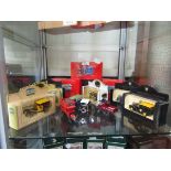 A collection of boxed and unboxed die cast buses, horse and carriages, and vans
