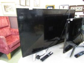 A Toshiba flat screen TV with remote