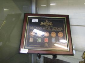 A framed and glazed display 'The Royal Centenary Collection Of Britain's Royal Lineage - A Century