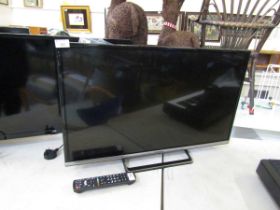 A Panasonic flat screen TV with remote