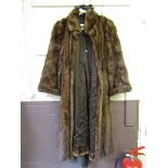 A brown fur coat by Claude Alexandre of Paris along with a Christian Dior furrier's bag