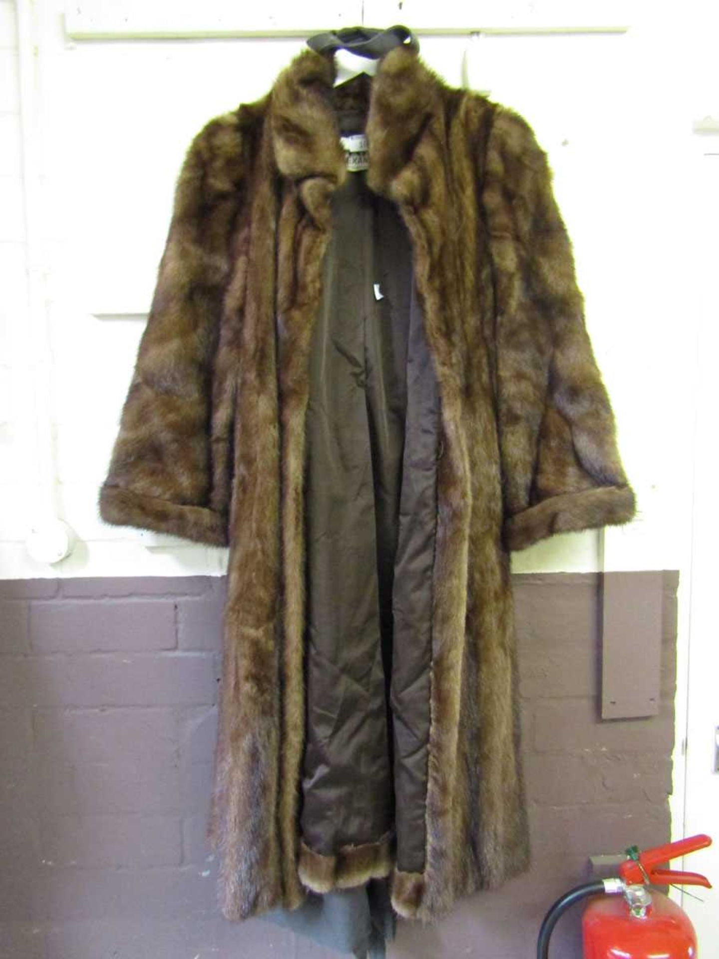 A brown fur coat by Claude Alexandre of Paris along with a Christian Dior furrier's bag