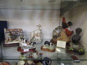An assortment of six cast figures to include Border Fine arts models of dogs, figural group of goats