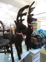 Two organic made reindeer decorations with red and white scarves